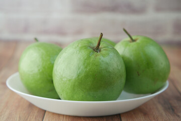 fresh guava on a plate on table 