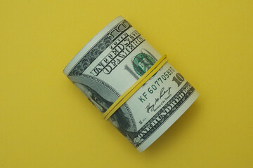 Fototapeta premium Dollars rolled up into a tube.