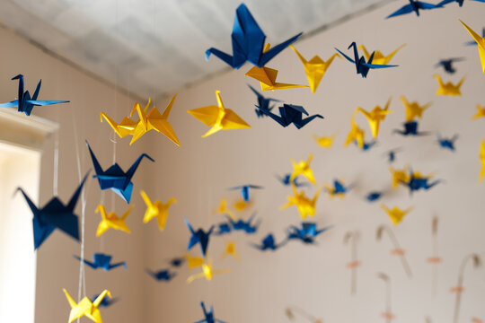Paper origami birds on a ropes, yellow blue, the color of the flag of Ukraine
