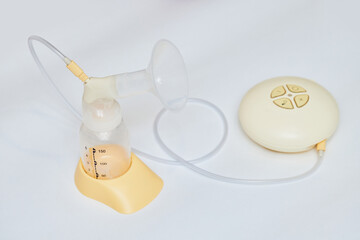 Breast pump with empty baby bottle on table