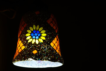 Colorful handmade ceramic lamps hanging in the home illuminate beautiful patterns of light