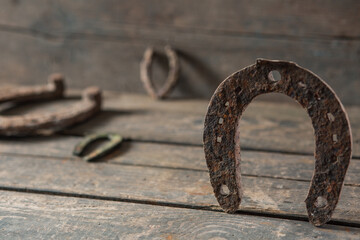 Old rusty horseshoe on a wooden background