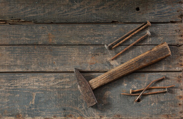 Old hammer and rusty nails on an old wooden box