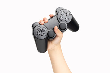 Shot of an little boy hand holding black gamepad show cool symbol on white background, minimalism concept. © cunaplus