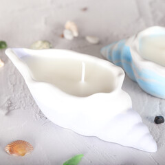 A candle in the shape of a shell. Plaster mold. Soy wax candle, inner candle.	