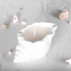 A candle in the shape of a shell. Plaster mold. Soy wax candle, inner candle.	