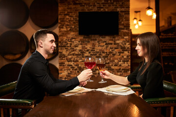 Young couple in love on a date in a restaurant..The boy and the girl are resting in a cozy place...