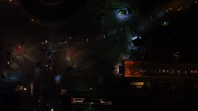 Drone view of busy streets at night in the center of Paris.