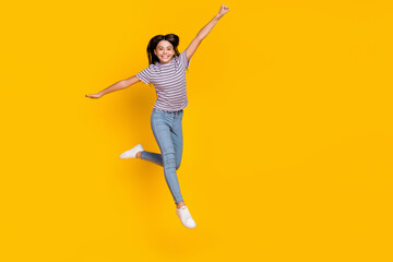 Full body photo of young pretty excited lady have fun jump up fly isolated over yellow color...