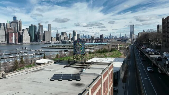 circling colorful Watertower water tank Manhattan skyline soccer field in Dumbo Brooklyn New York City