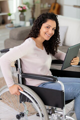 disabled woman on wheelchair using a tablet pc