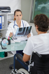 male patient with talking to doctor about xray