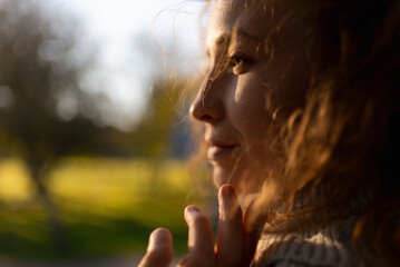 A young redhead woman is enjoying a relaxing moment with a blissful smile