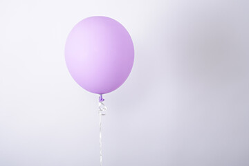one minimal purple balloon on white background, copy space, element of decorations for birthday party, wedding, festival