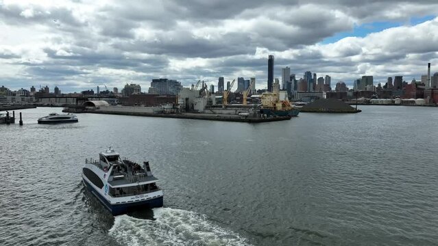 ferry boat crossing East River with Manhattan Bridge in distance New York City NYC