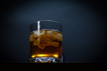 Glass of scotch whiskey and ice.