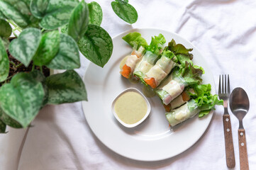 healthy food Seafood salad rolls in a white plate are ready to eat on the table.