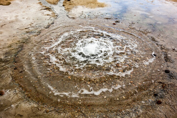Natural spring of mineral water. Cold geyser with small lake of water in natural reservation Siva Brada, Slovakia. Spontaneous springing of Carbon dioxide rich water.