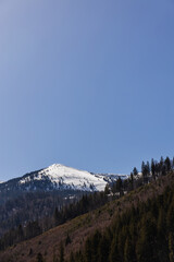 Scenic view of mountain with snow and blue sky at background.