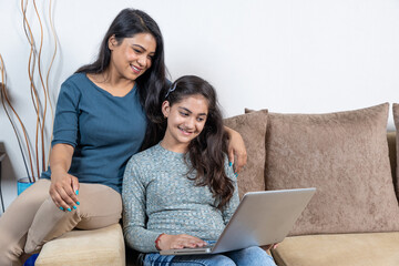 happy Mother and daughter looking at laptop 