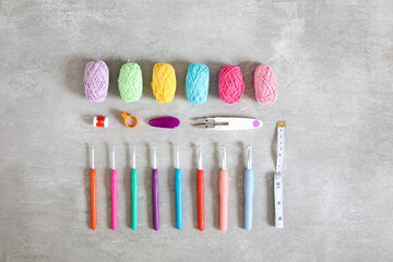Top view of colourful crochet accessories on a light grey background