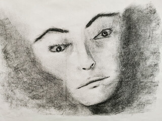 Charcoal drawing of a female face with a lost and pensive look. Copy space.