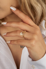 Golden Ring on a female hand, diamonds Diamond ring in hands of young lady. Close-up photo shoot