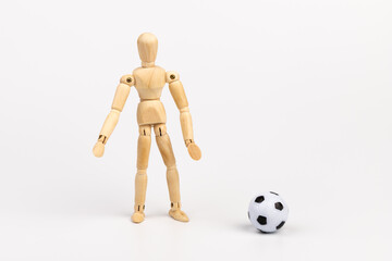 Wooden mannequin with soccer ball isolated on white background. Football player concept.