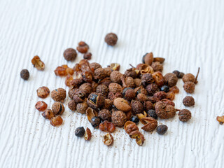 Handful of dried Chuang Chia spice seasoning. Sichuan pepper Zanthoxylum bungeanum close up, full frame. Food background.