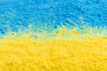 colorful Ukrainan flag yellow blue color holi paint powder explosion isolated on white background. russia ukraine conflict war freedom concept