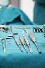 Surgical instruments, surgery, placed on a sterile green cloth, soft focus