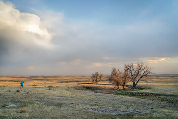 prairie in northern Colorado at early spring sunset with a lonely male figure - Soapstone Prairie...