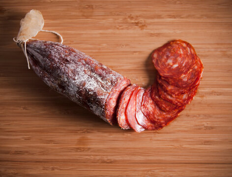 Sliced salami on cutting board