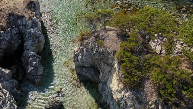 Rocky promontory with a strait between the rocks. Untouched nature. Drone view