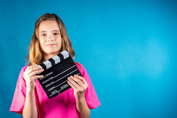 Young girl with a clapperboard gives a signal about the start filming. Concept of cinematography,...