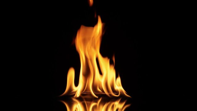 Lodernde Flammen mit Spiegelung auf schwarzem Hintergrund