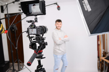 young man video camera operator making interview in professionnal broadcast tv movie studio film production