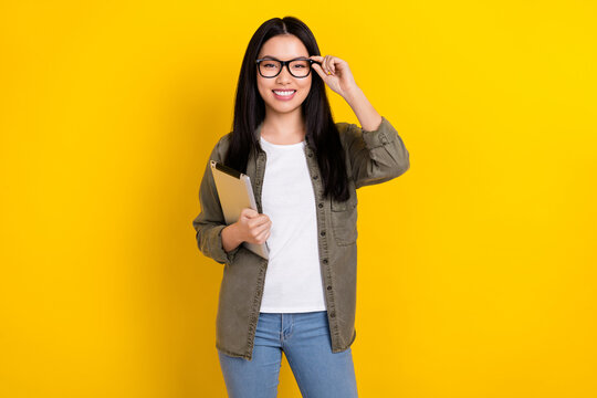 Photo of cheerful clever young student assistant working as trainee in modern company isolated on yellow color background