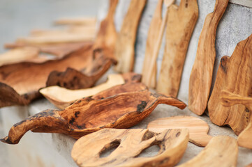 Kitchen utensils on outdoors Easter festival or weekend agricultural fair. Plates, bowls and cutting boards make of olive wood