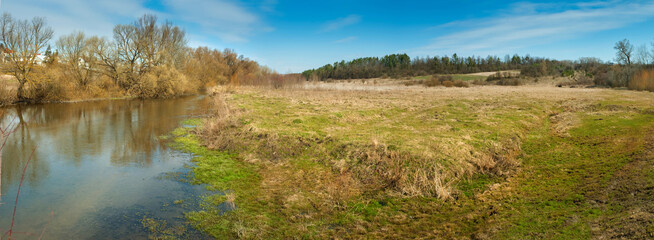 Fototapeta premium spring landscape panoramic view with river and meadow, early spring
