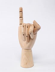 Wooden hand, little finger up on a white background