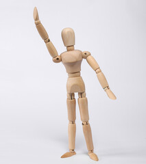Wooden puppet raises his hand up isolated on white background