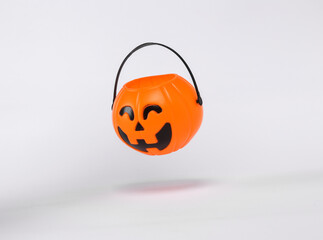 Floating Halloween jack pumpkin bucket on white background with shadow. Trick or Treat - Powered by Adobe
