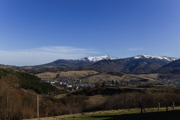 Village and mountains with blue sky at background.