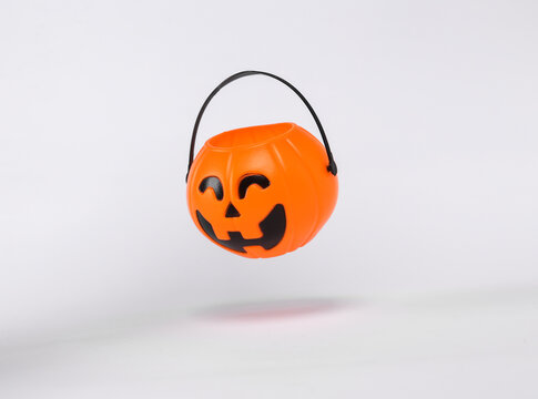 Floating Halloween jack pumpkin bucket on white background with shadow. Trick or Treat - Powered by Adobe