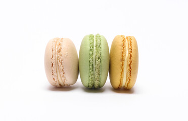 Stack of colored macaroons isolated on white background. French sweet delicacy.