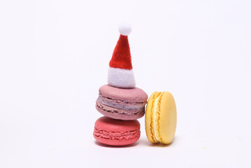 Christmas still life, santa hat with french macaroons isolated on white background