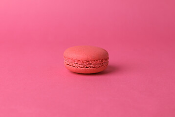 Obraz na płótnie Canvas Pink macaroon on pink background. French sweet delicacy. Color trend