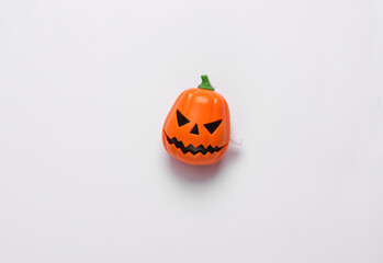 Clockwork toy jack pumpkin head on a white background. Halloween decor