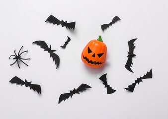 Halloween background with jack pumpkin head, spider and bats on white background. Top view. Flat lay